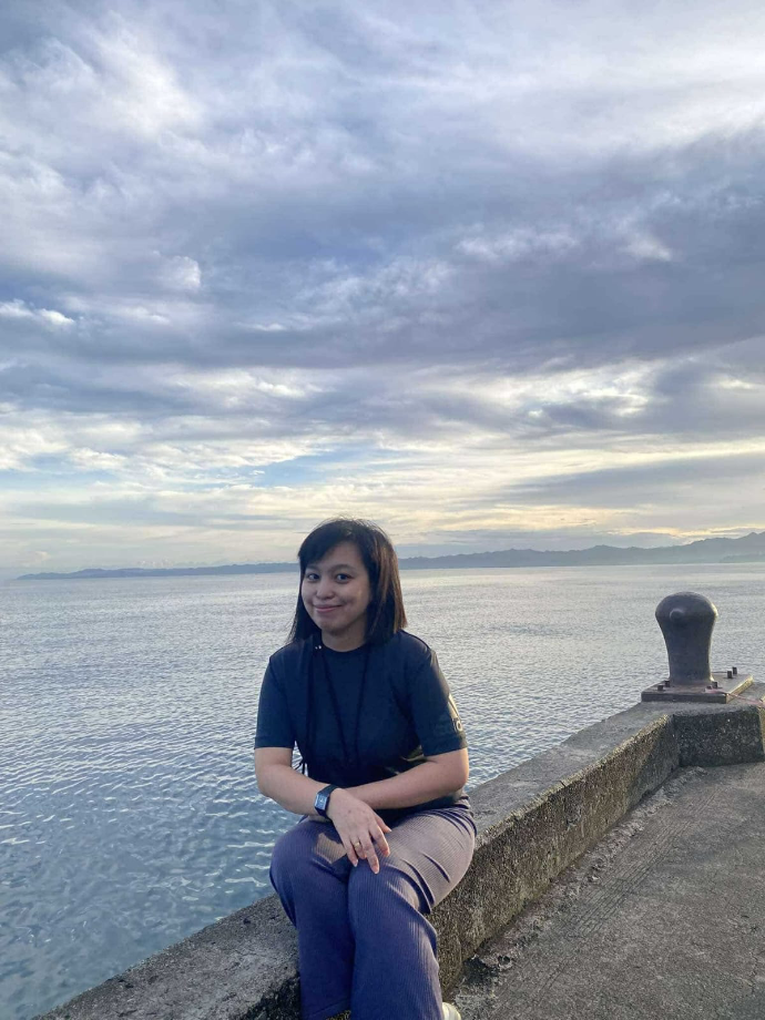 Liezl Villanueva Obedencio sitting near the water
