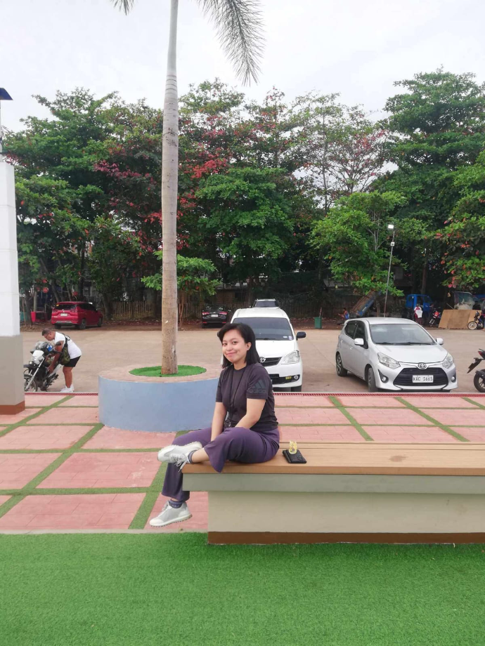 Liezl Villanueva Obedencio sitting with beautiful trees in the background